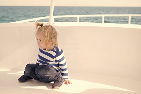 Child in striped shirt looks like young sailor.の写真素材