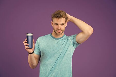 Handsome man with sexy body isolated on purpleの写真素材