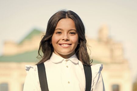 vintage kid fashion and beauty. schoolgirl in classy retro uniform. small happy girl ready to study....