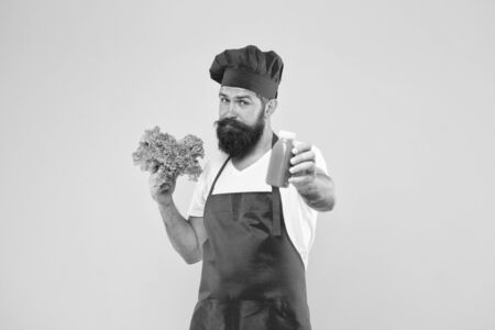 Hipster smoothie beverage. Concentrated freshness. Fresh juice. Squeezing smoothie. Man bearded chef hold lettuce and smoothie bottle yellow background. Vegetarian nutrition. Vitamin smoothie drinkの写真素材