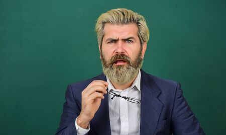 Inspiring quotes. Announcement school courses. Introduced and welcomed by university. Teacher explain topic. Man teacher in front of school chalkboard copy space. School advertisement conceptの写真素材