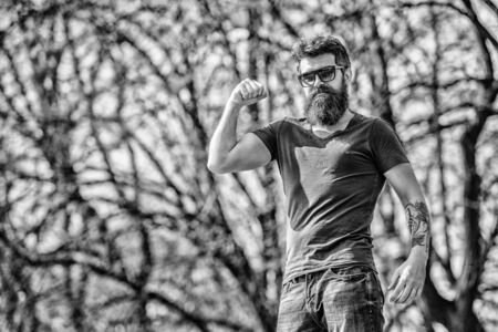 Bearded hipster brutal man wear protective sunglasses. Man bearded with sunglasses nature background. Hipster confident in dark sunglasses. Bearded man wear modern fashionable sunglasses. UV filterの写真素材