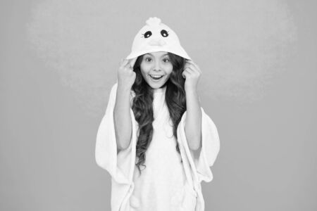 Happy childhood. Kid with long hair wear plush pajamas. Adorable pajamas. Little girl small child wearing cute pajamas with hood. Feeling cozy and comfortable. Kids fashion. Domestic clothesの写真素材