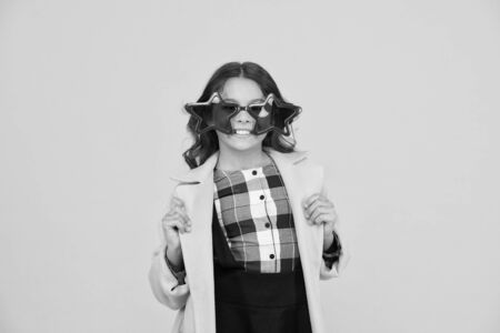 Rock star. Feeling like a superstar. Girl confident cool kid wear star shaped sunglasses. Star concept. Fame and popularity. Party holiday celebration. Cheerful girl wear eyeglasses for funの写真素材
