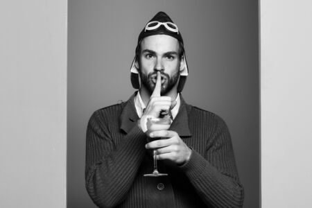 bearded pilot with cocktail in glass with long beardの写真素材