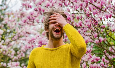 Guy relax in flowers park. Botanical garden. Freshness and awakening. Spring inspiration. April may. Joy of spring. Man flowers background. Spring beauty. Hipster enjoy blossom. Springtime concept.の写真素材