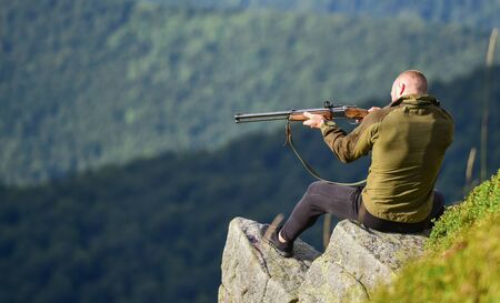 Hunter hold rifle. Hunter spend leisure hunting. Man brutal gamekeeper nature landscape background....