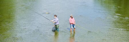 Summer weekend. Happy fisherman with fishing rod and net. Hobby and sport activity. Fishing...