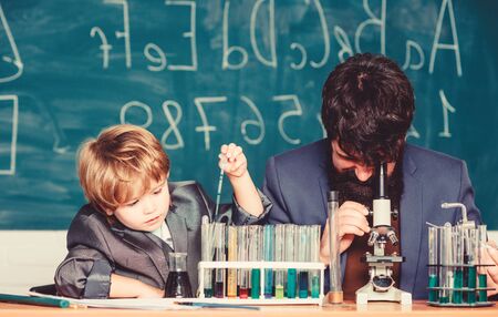 son and father at school. small boy with teacher man. Wisdom. Back to school. Chemistry and physics...