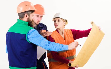 Men and woman in helmets, architects on busy faces