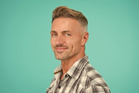 perfect male. portrait of real man. mature man unshaven face. smiling guy pleasant face. male skin and facial care. confident fashion model. barber salon services. sexy man turquoise backgroundの写真素材