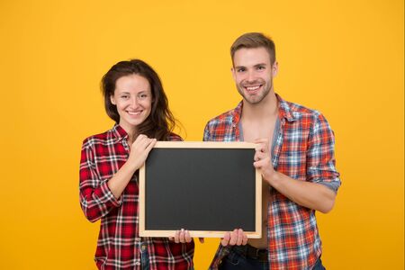 For Your Product Or Text. Modern school. our new home. party invitation. family day concept. time for sales and discounts. lets go shopping together. trendy couple hold blackboard, copy spaceの写真素材