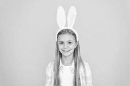 Looking top notch for Easter. Small girl child in easter bunny style. Cute little girl wearing bunny ears headband. Fashion accessory for easter costume party. Looking pretty in easter bunny attireの写真素材