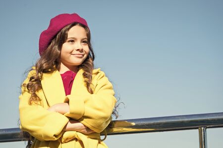 Childhood is about happy memories. Smiling little kid in hat sky background. Small girl wear fall outfit outdoors. Autumn bucket list. Farewell to autumn. Last autumn beams. Ideas for autumn leisureの写真素材