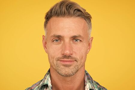 Male natural beauty. sexy man yellow background. portrait of real man. mature man unshaven face. smiling guy pleasant face. male skin and facial care. confident fashion model. barber salon servicesの写真素材