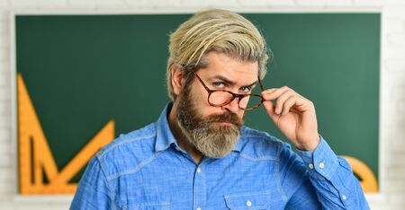 high school. back to school. man engineering graphics and projects. science in modern school. Math is favorite subject. study algebra in college. formal sciences. mature teacher in glasses.の写真素材