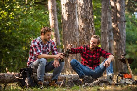 Relaxing Camping Experience. drink beer at picnic. campfire life story. spend free time together. family camping. hiking adventure. picnic in tourism camp. friends relaxing in park togetherの写真素材