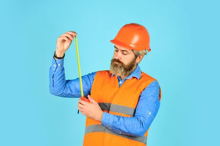 how long is it. Man in uniform works on the production. Industrial modern technology. builder with...