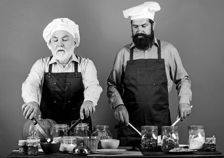 Chef men cooking. Father and son culinary hobby. Family restaurant. Selected ingredients. Mature...