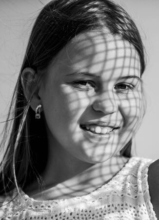 Child pleased with warm sunlight looks relaxed blue sky background. Take care. Summer care. Sunscreen concept. Take care skin put sunscreen cosmetics. Girl kid relaxing outdoors. Uv filter sunscreenの写真素材