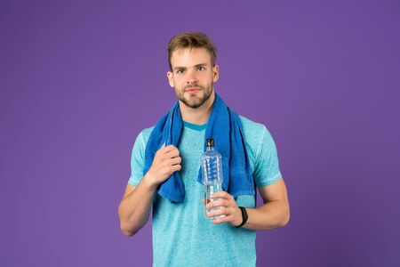 Man athletic hold water bottle. Handsome athlete drink water. Water balance. Sport for better life....