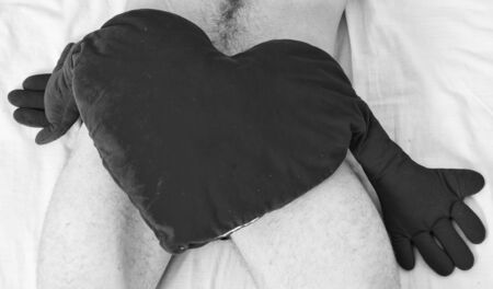 Love and sex concept. Valentines day surprise. Sexual health and libido. Ready to make love. Heart romantic symbol of love. Need to be loved. Male genitals covered with big red plush heart toyの写真素材