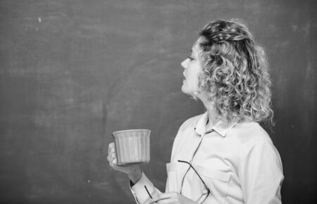 My morning coffee. school teacher need coffee break. good morning. girl refreshing with drink. woman with coffee cup at blackboard. energy and vigor. energy charge. idea and inspiration. copy space.の写真素材