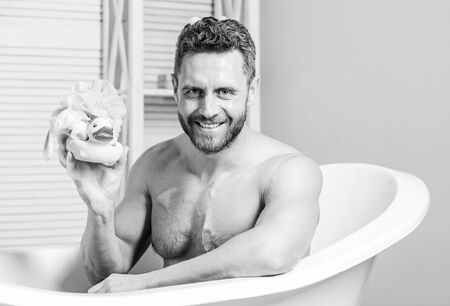 playful mood. macho enjoy bath. Sexy man in bathroom. Sex and relaxation concept. man wash muscular...