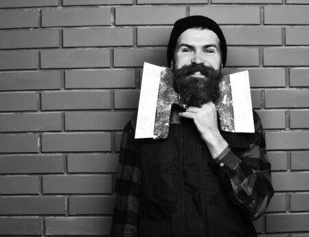 bearded man holding spatulas with happy faceの写真素材