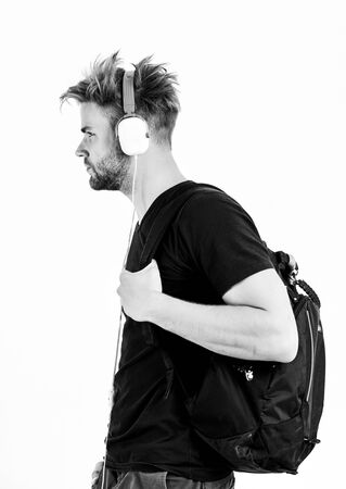 Student handsome guy listening music. Man tousled hairstyle wear plastic earphones gadget. Enjoy music everywhere you go. Rhythmic melody concept. Download music application. Youth music tasteの写真素材