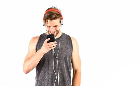 Audio track. Man handsome unshaven hipster listening audio file using headphones gadget. Modern...