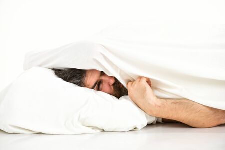 Rest and silence concept. Man with drowsy face lies