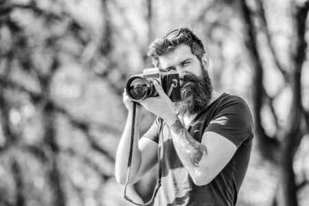 Mature hipster with beard. Bearded man. photo of nature. reporter or journalist. retro photographic equipment. hipster man in summer glasses. brutal photographer with camera. Confident photographerの写真素材