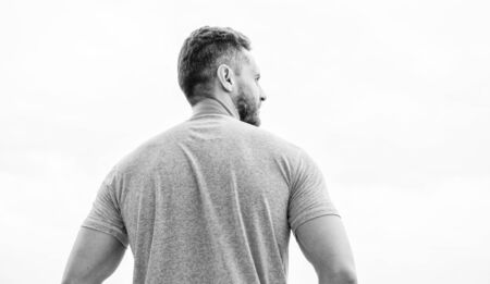 Strong muscular body feeling powerful rear view. Successful athlete. Victory and success. Champion winner. Future opportunity. Leadership and competition. Future concept. Looking forward in futureの写真素材