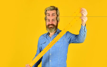 Studying with fun. Measurement tool. Teacher stem. Measuring centimeters. School education. Free education. Teaching geometry. Long or short. Bearded man use ruler. Education concept. School classesの写真素材