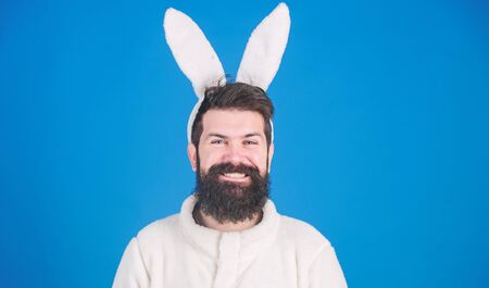In playful mood. Man wearing long rabbit ears. Bearded man in Easter rabbit costume. Easter bunny or hare. Hipster dressed for Easter party. Easter bunny is symbol of fertility and spring, copy spaceの写真素材