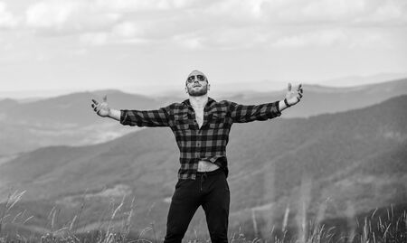 Man stand on top of mountain. Hug whole world. Hiking concept. Active leisure. Guy enjoy freedom. Masculinity and male energy. Achieve freedom. Free and wild. Value of freedom. Self sufficientの写真素材