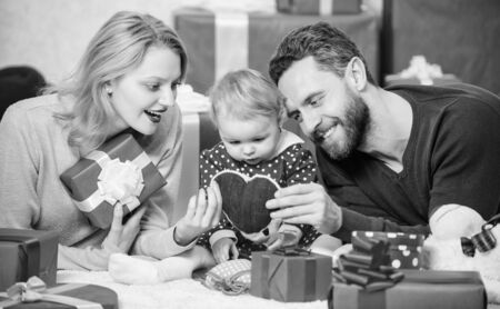 Shopping online. Happy loving couple. Happy family with present box. Love and trust in family. Bearded man and woman with little girl. Valentines day. Red boxes. father, mother and doughter childの写真素材