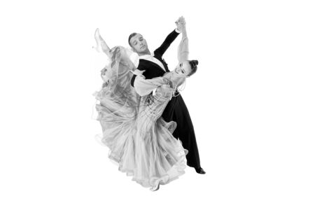 ballrom dance couple in a dance pose isolated on black background