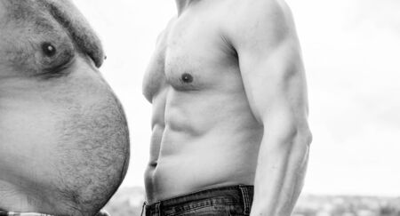 Turn beer belly into six packs abs in easy steps. Compare fat and six packs attractive torso. Male ugly fat belly and strong six packs muscles. Weight loss. Sport motivation. Get ready summer body.の写真素材