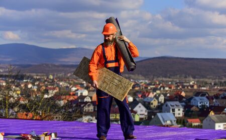 Roof installation. Man hard hat work outdoor. Building house. Roof Mechanic concept. Removing hazards. Inspect repair and replace. Fix or build. Provide safe access to roof. Roofer repair roofの写真素材