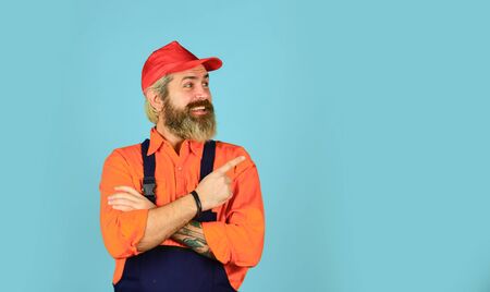 Mad repairman concept. man wear boilersuit. bearded worker in overalls. Confident Mature Mechanic. Portrait Of Repairman. Worker in storehouse. Caucasian workman in storeroom. copy spaceの写真素材