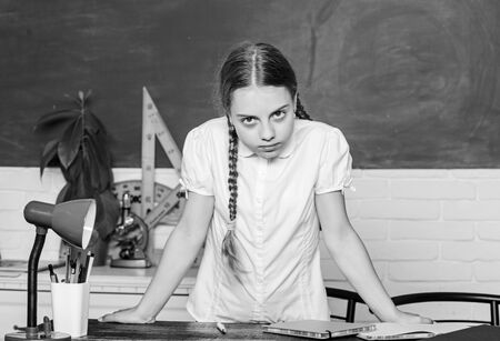 Hooked on learning. Hometask concept. Small kid study school. Girl cute child sit school classroom...