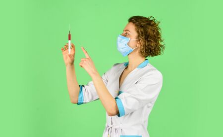 nurse wear respirator mask. Physician giving vaccine. HPV concept. Doctor with syringe is preparing for injection. injection against coronavirus. virus epidemic outbreak. immunity vaccinationの写真素材