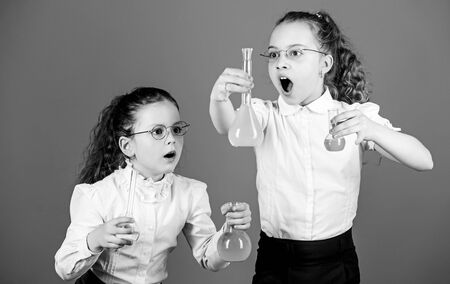 little smart girls with testing flask. back to school. school kid scientist studying science. biology education. children study chemistry lab, discovery. discovery concept. discover new elementの写真素材