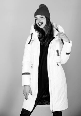 Christmas atmosphere around. woman in padded warm coat. beauty in winter clothing. cold season shopping. happy winter holidays. girl in beanie hat. faux fur fashion. flu and cold. seasonal fashionの写真素材