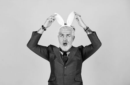 What a long ears. Bearded man touch bunny ears on head. Businessman wear bunny costume accessory....