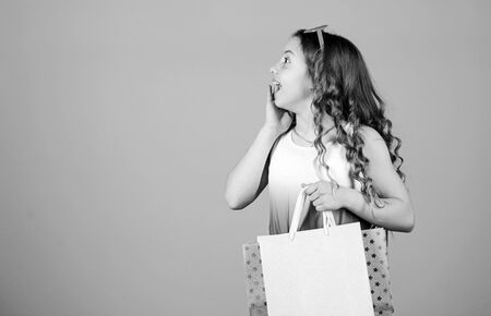 Black friday. Sale discount. Shopping day. Child fashion girl sunglasses hold package. Shopping tour abroad. Favorite kids brand. Girl with shopping bag. Summer season sale. Shopping and purchaseの写真素材