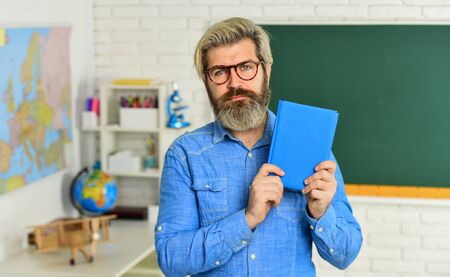Literature and poetry. Back to school. Bearded man reading book. Cognitive development. Teacher work...