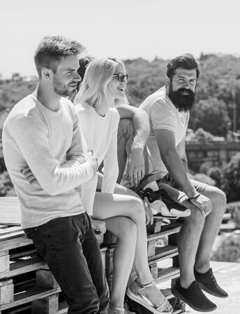 Having fun. best friends. Summer vacation. diverse young people talking together. group of four people. The great fit for the day off. Group of people in casual wear. cheerful men and girl relaxの写真素材